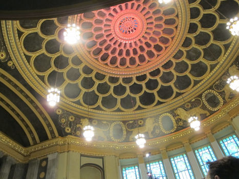 The interior of a dome featuring opulent roof decoration.