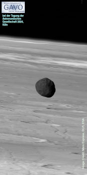 A 2:1 landscape black-and-white image with a blackish irregular spheroid floating in front of a deep horizon.