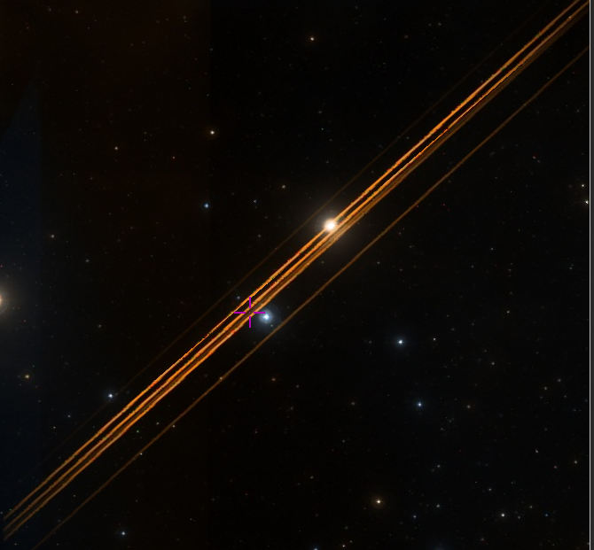 A sky image some stars and a few diagonal red streaks going from lower left to upper right.